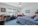 Bedroom with ample light, ceiling fan, blue carpet, and a window overlooking the outdoors at 739 Stiles Dr, Charleston, SC 29412
