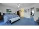 An airy bedroom with a blue patterned bed, wooden dresser, and a view to the hallway at 739 Stiles Dr, Charleston, SC 29412