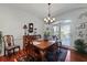 Elegant dining area with wooden table, chandelier, and natural light from glass doors to the exterior at 739 Stiles Dr, Charleston, SC 29412