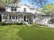Traditional home featuring a welcoming front porch and a well-kept lawn at 739 Stiles Dr, Charleston, SC 29412