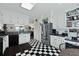 The spacious kitchen features bright white cabinets, black and white floors and stainless steel appliances at 739 Stiles Dr, Charleston, SC 29412