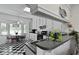 Bright kitchen area with bar seating, black and white tile floor, and stainless steel sink at 739 Stiles Dr, Charleston, SC 29412
