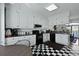 Well-lit kitchen featuring black appliances and a black and white checkerboard floor at 739 Stiles Dr, Charleston, SC 29412