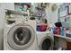 Efficient laundry area with front-load washer, dryer, and shelving for storage at 739 Stiles Dr, Charleston, SC 29412