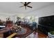 Open-concept living room with hardwood floors, fireplace, and large windows at 739 Stiles Dr, Charleston, SC 29412