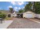 View of backyard with garage, boat carport, shed, and gravel area surrounded by a white fence at 798 Rutledge Ave, Charleston, SC 29403