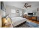 Comfortable bedroom with ample natural light, stylish ceiling fan, and beautiful hardwood floors at 798 Rutledge Ave, Charleston, SC 29403