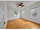 Light filled bedroom with hardwood floors, three windows, and a classic ceiling fan at 798 Rutledge Ave, Charleston, SC 29403