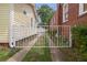 Long driveway secured by a white wrought iron gate leading to the backyard garage at 798 Rutledge Ave, Charleston, SC 29403