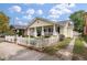 Charming home with a manicured lawn, inviting front porch, decorative fence and private driveway at 798 Rutledge Ave, Charleston, SC 29403