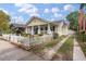 A well-maintained home featuring a charming white picket fence and established landscaping at 798 Rutledge Ave, Charleston, SC 29403