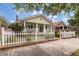 Charming home with a picket fence, lush landscaping, and a welcoming front porch at 798 Rutledge Ave, Charleston, SC 29403