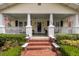 Inviting front porch with classic columns and brick steps at 798 Rutledge Ave, Charleston, SC 29403