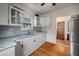 Well-lit kitchen with granite counters, white cabinets, and stainless-steel appliances at 798 Rutledge Ave, Charleston, SC 29403