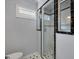 Modern shower with black and white tile, glass doors, and ample natural light at 798 Rutledge Ave, Charleston, SC 29403