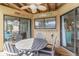 Cozy balcony features wood ceiling with ceiling fan and comfortable dining seating at 9000 Palmetto Dr # 202-C, Isle of Palms, SC 29451