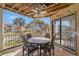 Outdoor balcony featuring a wood ceiling, ceiling fan, and a dining table at 9000 Palmetto Dr # 202-C, Isle of Palms, SC 29451