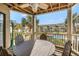 Balcony overlooking pool, features wood ceiling, ceiling fan, and dining table at 9000 Palmetto Dr # 202-C, Isle of Palms, SC 29451