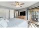 Comfortable bedroom with balcony access, dresser, and ample closet space at 9000 Palmetto Dr # 202-C, Isle of Palms, SC 29451