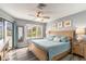 Light-filled bedroom with balcony access, ceiling fan, and neutral paint at 9000 Palmetto Dr # 202-C, Isle of Palms, SC 29451
