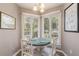 Cozy dining area with a round table and seating for four near bright, sunny windows at 9000 Palmetto Dr # 202-C, Isle of Palms, SC 29451