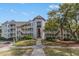 Condominium building featuring multiple stories and private balconies with lush landscaping and walkway at 9000 Palmetto Dr # 202-C, Isle of Palms, SC 29451