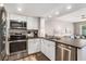 Updated kitchen with white cabinetry, stainless steel appliances, and modern countertops at 9000 Palmetto Dr # 202-C, Isle of Palms, SC 29451