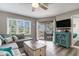 Comfortable living room features a sectional sofa, coffee table, and sliding glass door to a private balcony at 9000 Palmetto Dr # 202-C, Isle of Palms, SC 29451