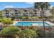 Community pool surrounded by lush greenery and landscaping at 9000 Palmetto Dr # 202-C, Isle of Palms, SC 29451