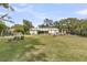 Expansive backyard features lush lawn, mature trees, and a tranquil screened-in porch at 939 Mikell Dr, Charleston, SC 29412