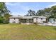 Expansive backyard featuring a screened porch, lawn, and outdoor seating areas at 939 Mikell Dr, Charleston, SC 29412