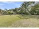 Large backyard with lush green lawn, gazebos, and mature trees at 939 Mikell Dr, Charleston, SC 29412