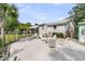 Inviting backyard with a sand area featuring a fire pit and lounge chairs for relaxing and entertaining at 939 Mikell Dr, Charleston, SC 29412