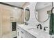 Modern bathroom boasts a double vanity with stone countertops and a sleek glass-enclosed shower at 939 Mikell Dr, Charleston, SC 29412