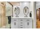 Modern bathroom boasts a double vanity with stone countertops and a sleek glass-enclosed shower at 939 Mikell Dr, Charleston, SC 29412