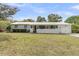 Charming single story home with white painted brick and a screened in porch at 939 Mikell Dr, Charleston, SC 29412