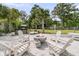 Relaxing backyard with a modern fire pit, lounge chairs, and lush landscaping for outdoor enjoyment at 939 Mikell Dr, Charleston, SC 29412