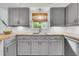 Updated kitchen featuring gray cabinets, butcher block countertops, and modern stainless steel appliances at 939 Mikell Dr, Charleston, SC 29412