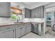 Updated kitchen featuring gray cabinets, butcher block countertops, and modern stainless steel appliances at 939 Mikell Dr, Charleston, SC 29412