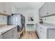 Well-organized laundry room with modern washer and dryer, storage cabinets, and granite countertops at 939 Mikell Dr, Charleston, SC 29412
