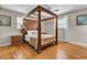 Main bedroom featuring hardwood floors, natural light, and a four-poster wooden bed at 939 Mikell Dr, Charleston, SC 29412
