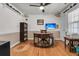 Dedicated office space featuring hardwood floors, a large wooden desk, and natural light at 939 Mikell Dr, Charleston, SC 29412