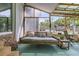 Inviting sunroom featuring a swinging daybed and ample windows for natural light and outdoor views at 939 Mikell Dr, Charleston, SC 29412