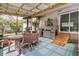 Inviting sunroom featuring a wood dining set and a backyard kitchen area at 939 Mikell Dr, Charleston, SC 29412