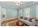 Serene bedroom space with light blue walls, a comfortable couch, and shuttered windows for optimal light control at 1002 Blockade Runner Ct, Charleston, SC 29414