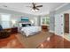 Spacious bedroom with hardwood floors, two windows and a comfortable bed at 1002 Blockade Runner Ct, Charleston, SC 29414