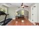 Attic bedroom with natural light and hardwood floors. A treadmill and guest bed are also included at 1002 Blockade Runner Ct, Charleston, SC 29414