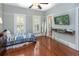 Bright bedroom with polished wood floors, a ceiling fan, and large sunny windows at 1002 Blockade Runner Ct, Charleston, SC 29414