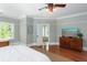 Bedroom with a large window, hardwood floors, and view into the bathroom at 1002 Blockade Runner Ct, Charleston, SC 29414