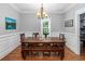Traditional dining room features a wood table with bench seating, wainscoting, and a decorative light fixture at 1002 Blockade Runner Ct, Charleston, SC 29414